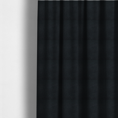 The fabric used to create these made-to-measure curtains is a textured charcoal black bouclé upholstery fabric.