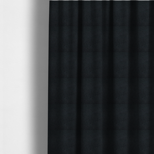 The fabric used to create these made-to-measure curtains is a textured charcoal black bouclé upholstery fabric.