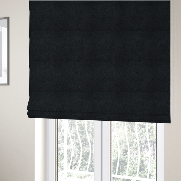 The fabric used to create these Roman blinds is a textured charcoal black bouclé upholstery fabric.