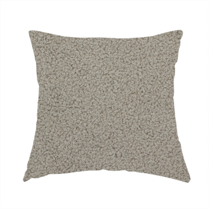 The fabric used to create this handmade cushion is a textured taupe or light grey bouclé upholstery fabric.