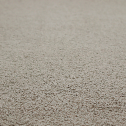 A textured taupe or light grey bouclé upholstery fabric.