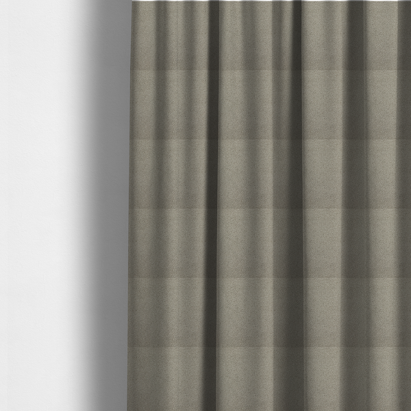The fabric used to create these made-to-measure curtains is a textured taupe or light grey bouclé upholstery fabric.