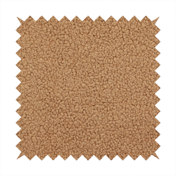 A textured camel brown bouclé upholstery fabric.