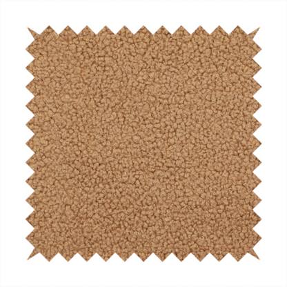 A textured camel brown bouclé upholstery fabric.