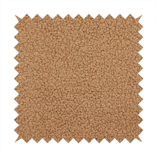 A textured camel brown bouclé upholstery fabric.