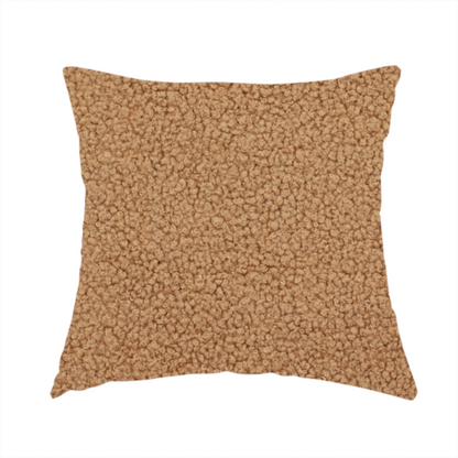 The fabric used to create this handmade cushion is a textured camel brown bouclé upholstery fabric.