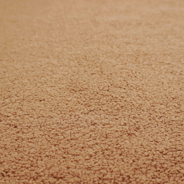 A textured camel brown bouclé upholstery fabric.
