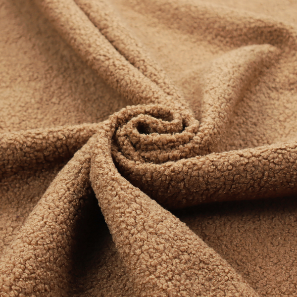 A textured camel brown bouclé upholstery fabric.