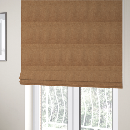The fabric used to create these Roman blinds is a textured camel brown bouclé upholstery fabric.