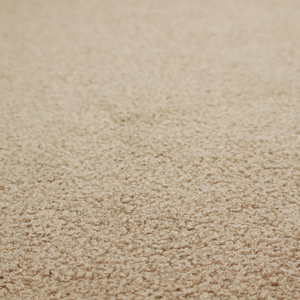 A textured khaki or warm taupe bouclé upholstery fabric.