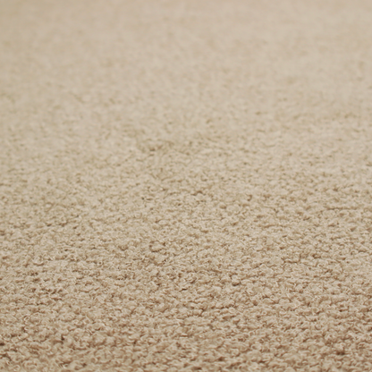 A textured khaki or warm taupe bouclé upholstery fabric.
