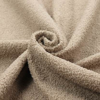 A textured khaki or warm taupe bouclé upholstery fabric.