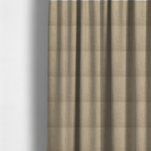The fabric used to create these made-to-measure curtains is a textured khaki or warm taupe bouclé upholstery fabric.