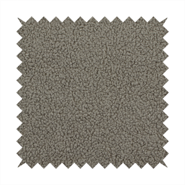 A textured greyish-brown or elephant grey bouclé upholstery fabric.