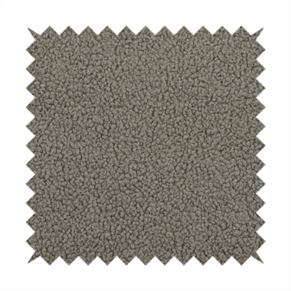 A textured greyish-brown or elephant grey bouclé upholstery fabric.