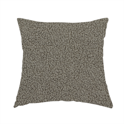 The fabric used to create this handmade cushion is a textured greyish-brown or elephant grey bouclé upholstery fabric.