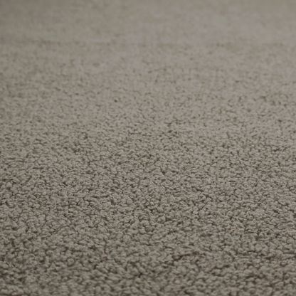 A textured greyish-brown or elephant grey bouclé upholstery fabric.