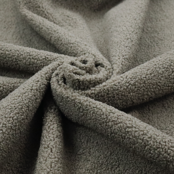 A textured greyish-brown or elephant grey bouclé upholstery fabric.