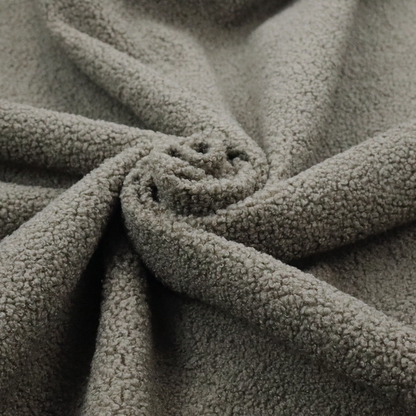 A textured greyish-brown or elephant grey bouclé upholstery fabric.
