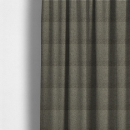 The fabric used to create these made-to-measure curtains is a textured greyish-brown or elephant grey bouclé upholstery fabric.