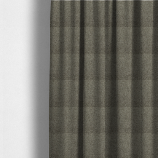 The fabric used to create these made-to-measure curtains is a textured greyish-brown or elephant grey bouclé upholstery fabric.