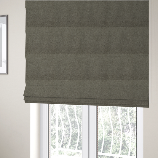 The fabric used to create these Roman blinds is a textured greyish-brown or elephant grey bouclé upholstery fabric.