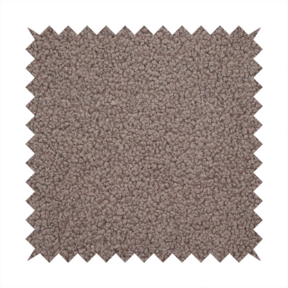 A textured rosy-brown or mauve bouclé upholstery fabric.