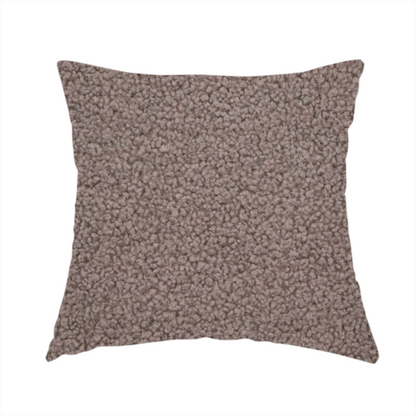 The fabric used to create this handmade cushion is a textured rosy-brown or mauve bouclé upholstery fabric.