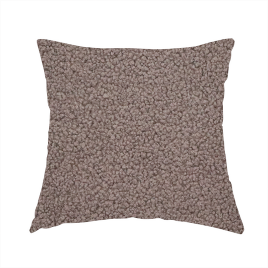 The fabric used to create this handmade cushion is a textured rosy-brown or mauve bouclé upholstery fabric.