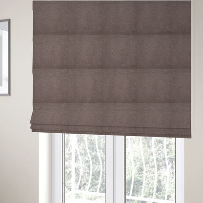 The fabric used to create these Roman blinds is a textured rosy-brown or mauve bouclé upholstery fabric.