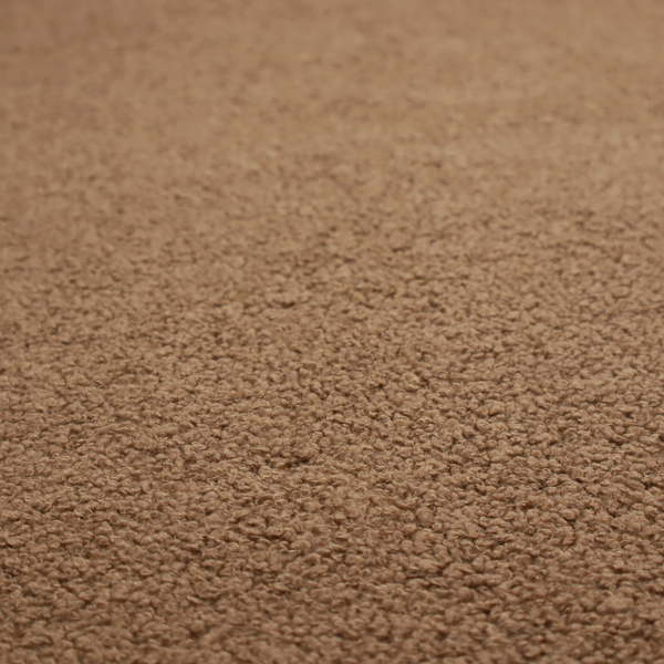 A textured medium brown or chestnut bouclé upholstery fabric.