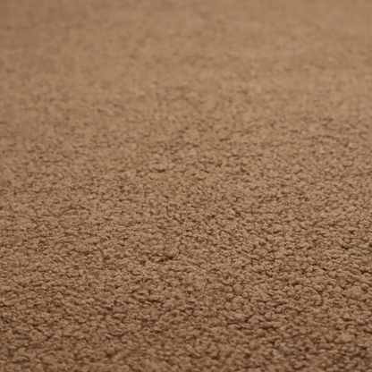 A textured medium brown or chestnut bouclé upholstery fabric.