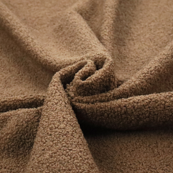A textured medium brown or chestnut bouclé upholstery fabric.