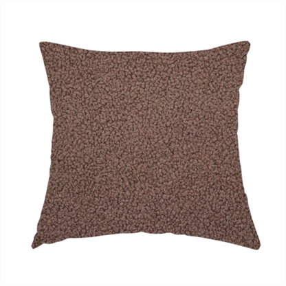 The fabric used to create this handmade cushion is a textured chocolate brown bouclé upholstery fabric.