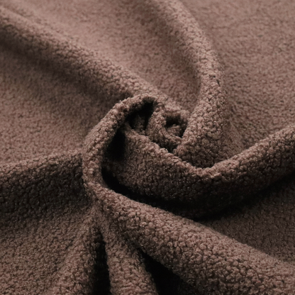 A textured chocolate brown bouclé upholstery fabric.