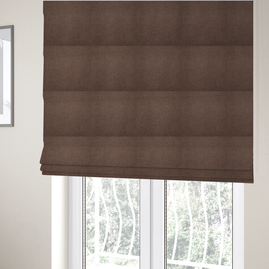 The fabric used to create these Roman blinds is a textured chocolate brown bouclé upholstery fabric.