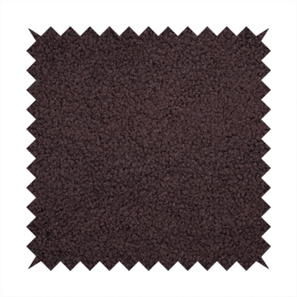 A textured dark espresso brown or deep plum bouclé upholstery fabric.