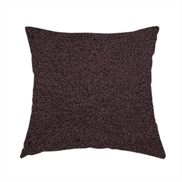 The fabric used to create this handmade cushion is a textured dark espresso brown or deep plum bouclé upholstery fabric.