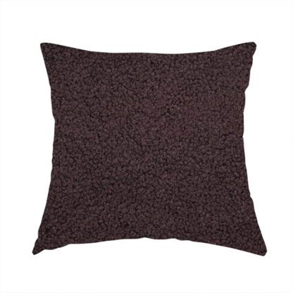 The fabric used to create this handmade cushion is a textured dark espresso brown or deep plum bouclé upholstery fabric.