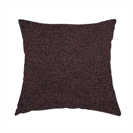 The fabric used to create this handmade cushion is a textured dark espresso brown or deep plum bouclé upholstery fabric.