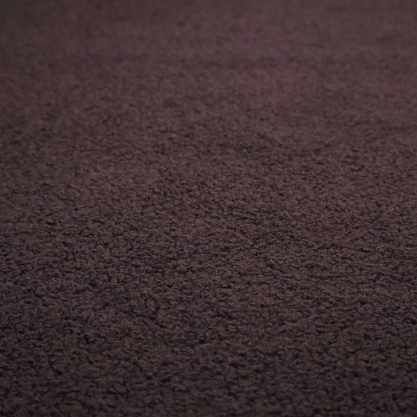 A textured dark espresso brown or deep plum bouclé upholstery fabric.