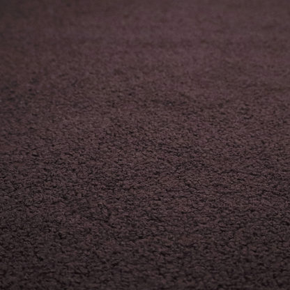 A textured dark espresso brown or deep plum bouclé upholstery fabric.