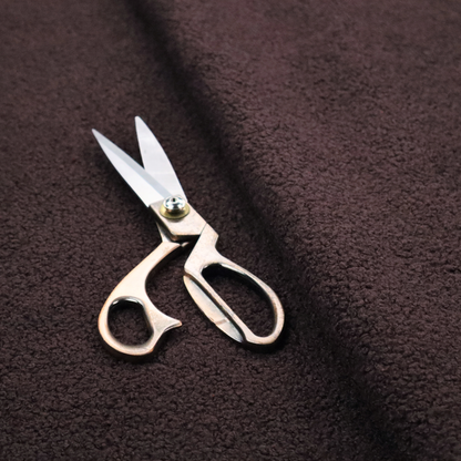 A textured dark espresso brown or deep plum bouclé upholstery fabric.