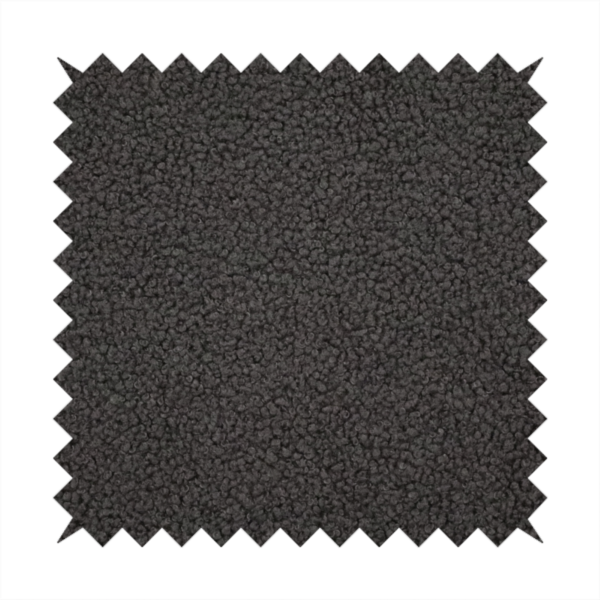 A textured charcoal grey bouclé upholstery fabric.