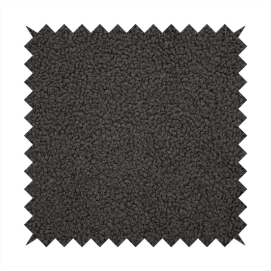 A textured charcoal grey bouclé upholstery fabric.