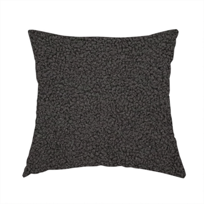 The fabric used to create this handmade cushion is a textured charcoal grey bouclé upholstery fabric.