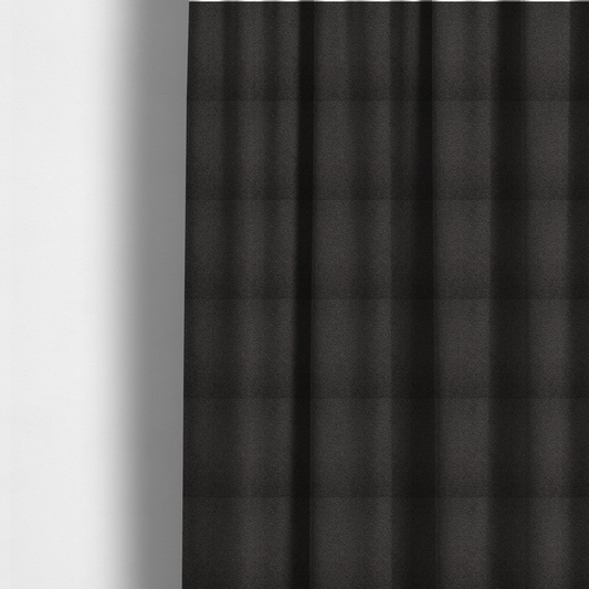 The fabric used to create these made-to-measure curtains is a textured charcoal grey bouclé upholstery fabric.