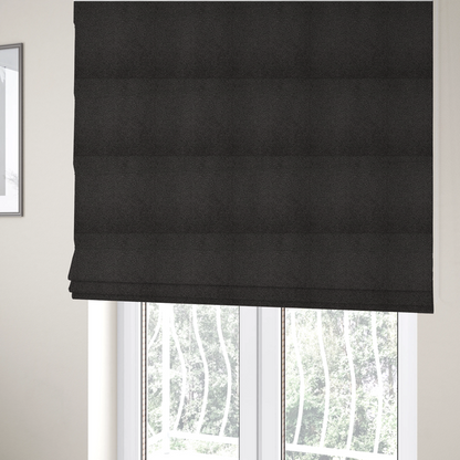 The fabric used to create these Roman blinds is a textured charcoal grey bouclé upholstery fabric.