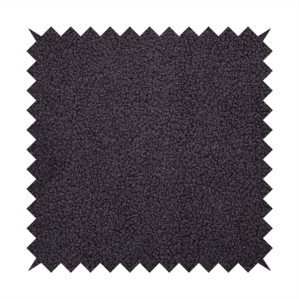 A textured dark plum or deep charcoal purple bouclé upholstery fabric.