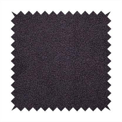 A textured dark plum or deep charcoal purple bouclé upholstery fabric.